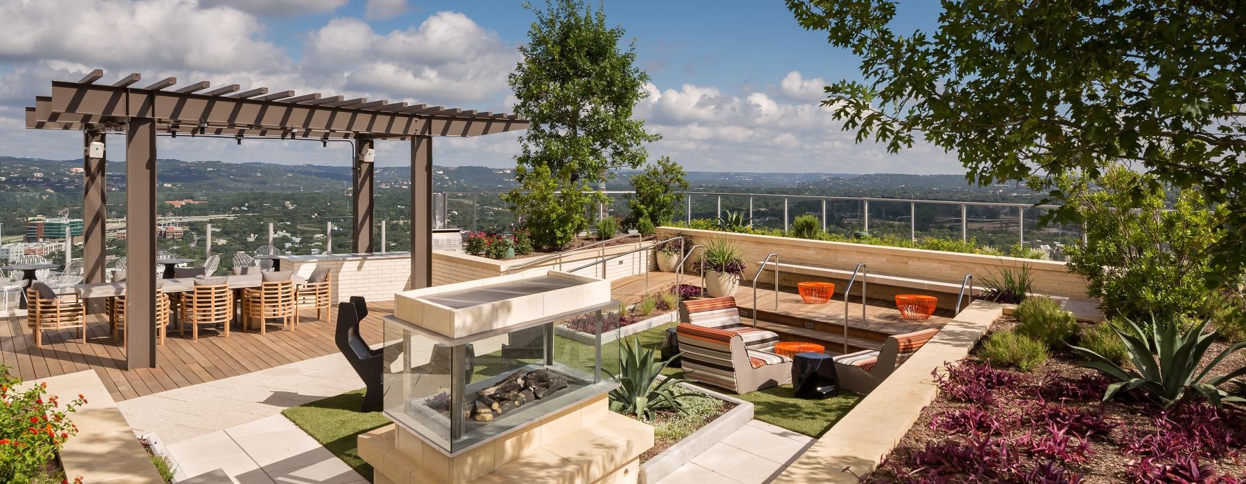 a patio with tables and chairs and a fireplace