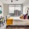 a bedroom with hardwood floors and large window