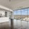 a large living room with tall windows and wood flooring